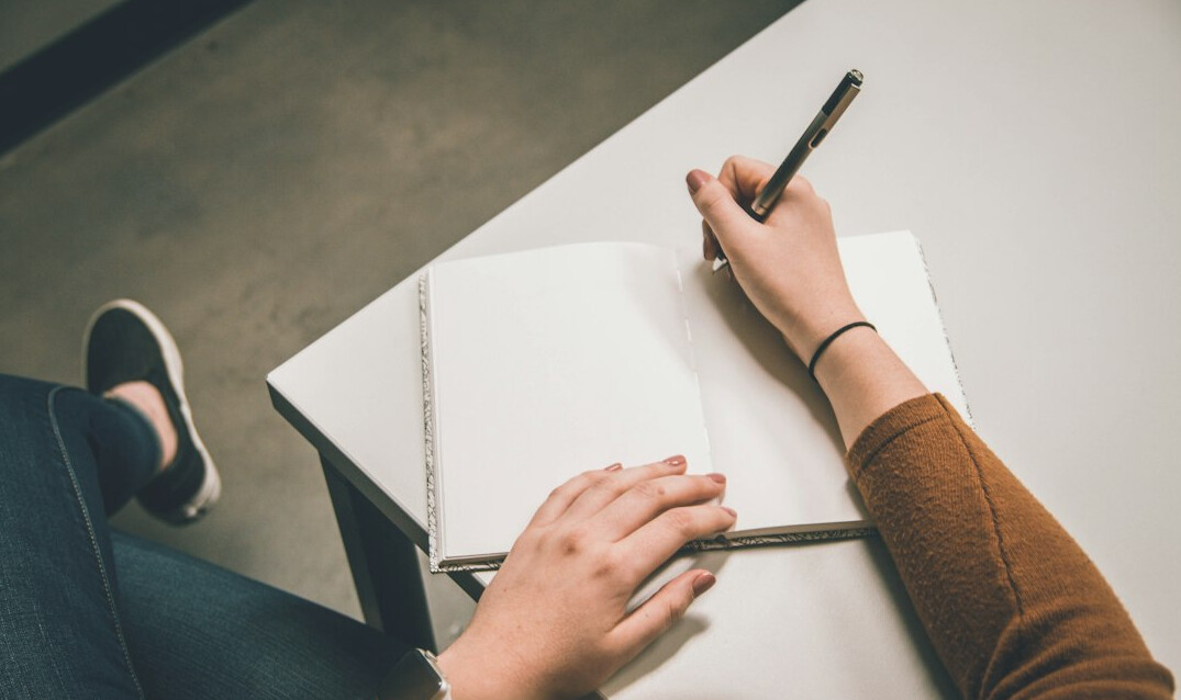 person writing goals on paper