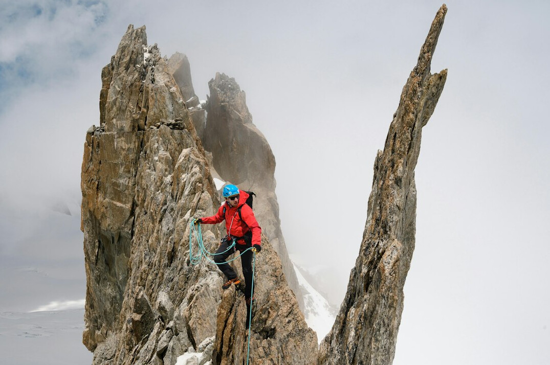 person climbing mountain